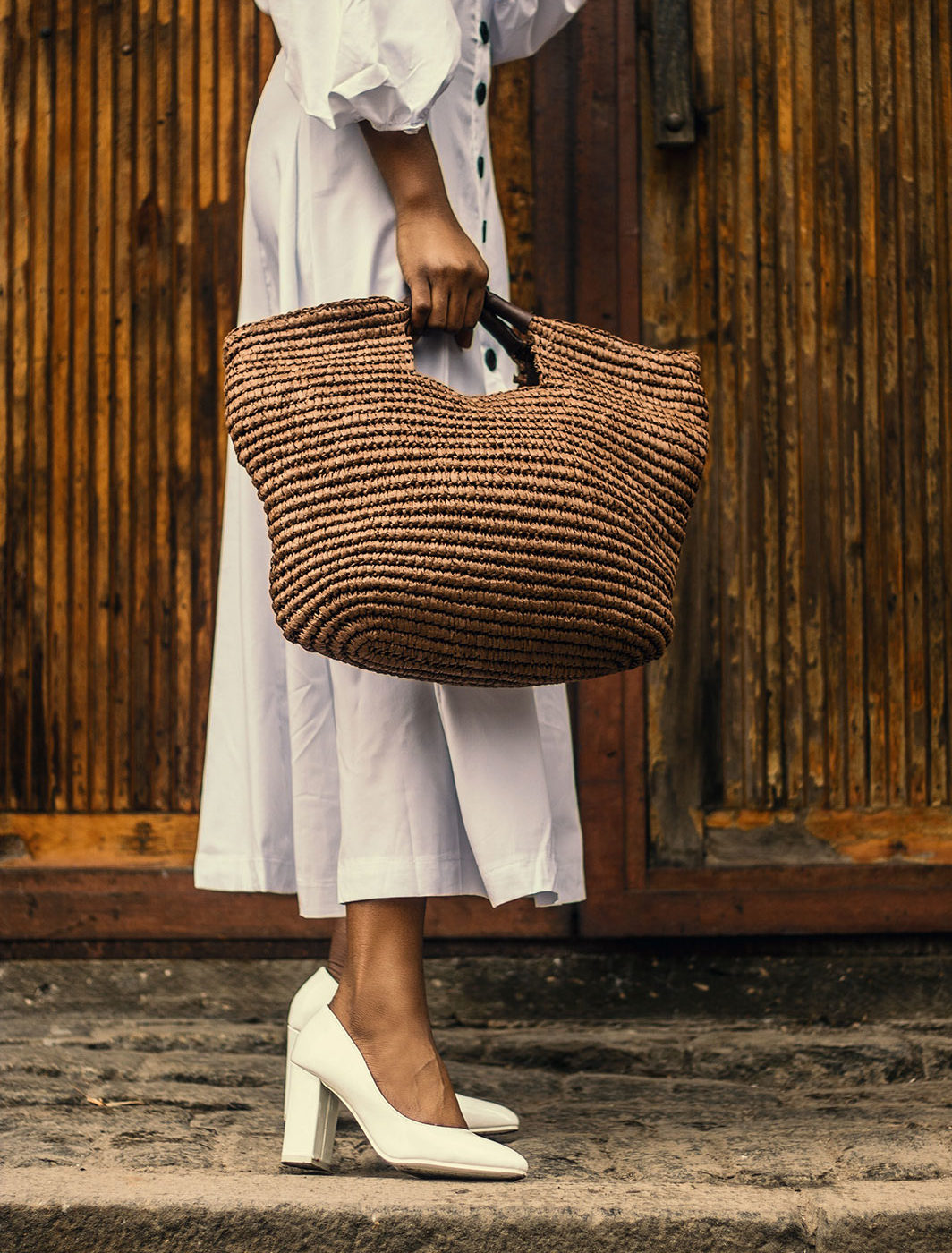 woman-holding-brown-bag-near-brown-wooden-surfac-1942879